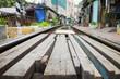 Wooden path crossing railway rail in Vietnam. Concept of unsafe railway