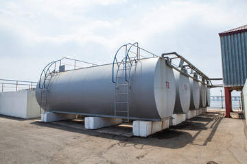 Huge oil, gas and liquid storage tanks in open air field at factory