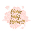 © viairevi - Gold inscription 'bloom baby, bloom' written by hand, in a trendy calligraphic style, on a gentle pink bouquet of peonies