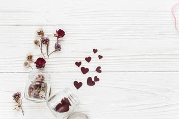 Wall Mural - stylish hearts in glass jar and roses flat lay on white wooden b