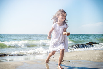 Happy little girl on the beach