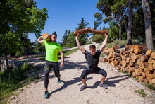Two Young Men Doing Weightlifting Training With Logs In Forest, Split, Dalmatia, Croatia