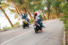 Rear View Of Two Couples Riding Mopeds On Rural Road, Split, Dalmatia, Croatia