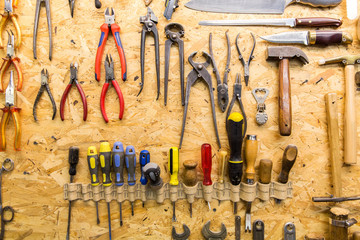 Wall Mural - work tools hanging on wall at workshop