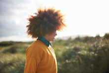 Woman With Afro Hair On Grassy Dune