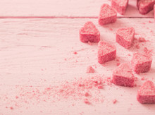 Granulated Pink Sugar  In The Shape Of Heart On A Wooden Backgro