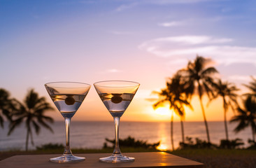 Wall Mural - Pair of martini glasses and a beautiful beach sunset. 