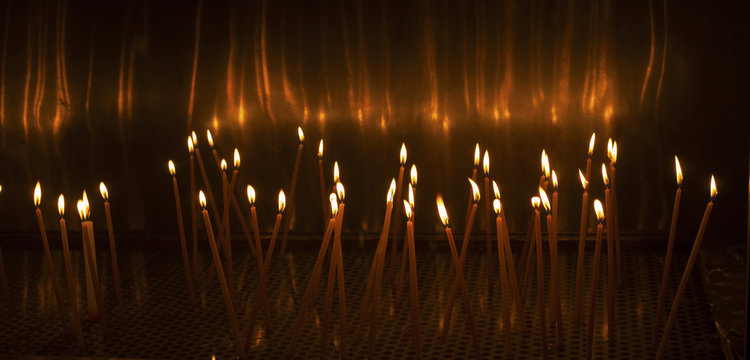 Church candles glowing in the dark