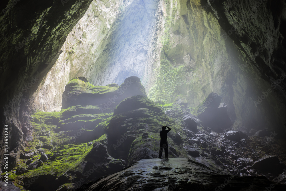 Mystery misty cave entrance in Son Doong Cave, the largest cave in the world in UNESCO World Heritage Site Phong Nha-Ke Bang National Park, Quang Binh province, Vietnam - obrazy, fototapety, plakaty 