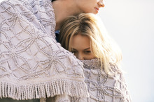 Romantic Couple Wrapped In Blanket Outdoors