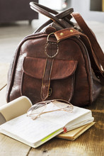 Leather Bag And Books On Table At Home Office