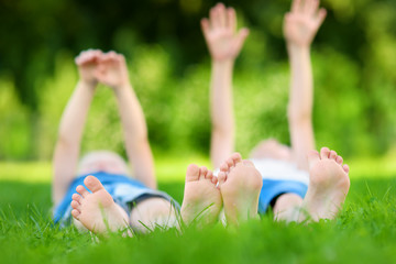 Two childrens feet on grass outdoors