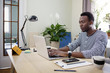© Cavan Images - Businessman working on laptop while sitting at home office
