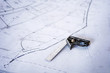 © Cavan Images - High angle view of measuring equipment on blueprint at construction site