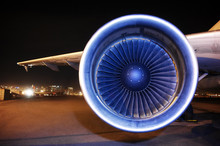 View Of Aircraft Jet Engine On Runway At Night