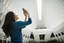 Side View Of Woman Photographing Ceiling In One World Trade Center