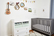 © Cavan Images - Decor with guitar on wall over drawer by crib in room