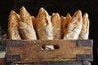 © Cavan Images - Bread loaves in wooden container at bakery