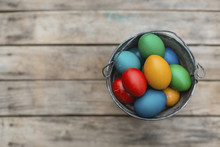Overhead View Of Easter Eggs In Bucket On Wooden Table