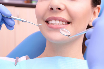 Wall Mural - Dentist examining patient's teeth in clinic, closeup