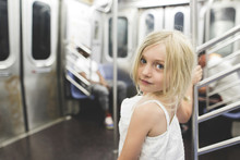 Portrait Of Smiling Girl Standing In Train