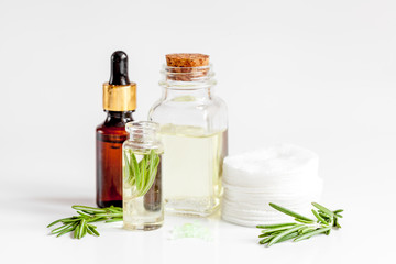 organic cosmetics with extracts of herbs rosemary on white background