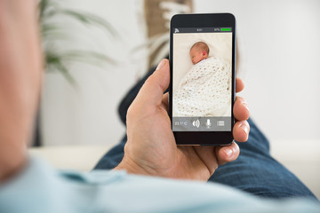 person looking at his baby on babyphone