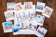 © Andrey Popov - Holiday Photos On Wooden Desk