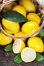 Fresh Lemons In A Basket On A Wooden Table