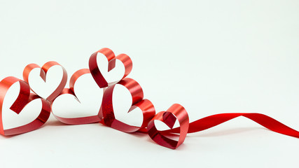 Ribbons shaped as hearts on white background, valentine day conc