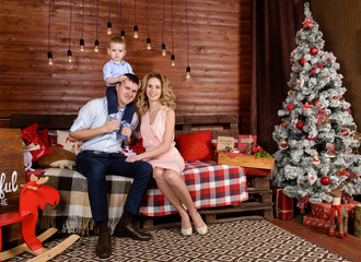 happy family with little son at Christmas on the background of C