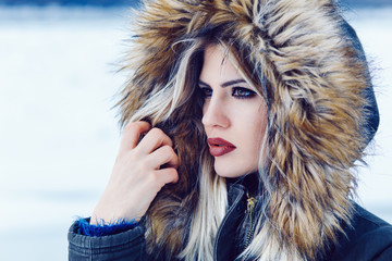 Portrait of a young beautiful woman on winter day