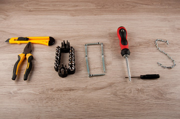 Word tools consist of different repair equipment on wooden background