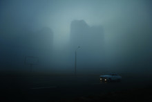 Skyscrapers At Early Foggy Morning At The City District. Lonely Retro Car On The Street.
