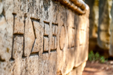 Wall Mural - Ancient script hieroglyph carved on stone block in Athens, Greece