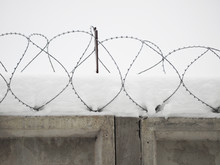 Barbed Wire On A Fence In The Snow