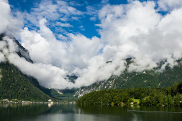 view of the lake and mountains with clouds