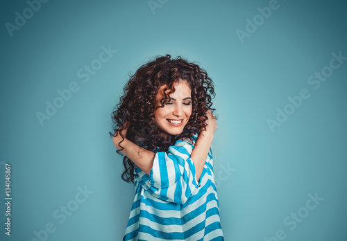 Fotomural Closeup portrait confident smiling woman holding hugging herself isolated blue wall background