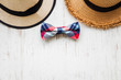 © arthorn - Men's accessories with brown hat and plaid bow tie on rustic wooden background
