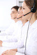 © rogerphoto - Call center. Focus on beautiful woman in headset