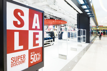 corridor with sign of sale in modern shopping mall