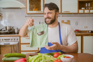 Wall Mural - a man cooks in the kitchen