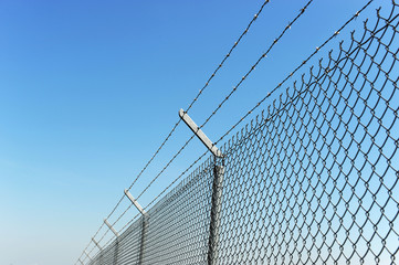 Wall Mural - iron chain link fence and blue sky