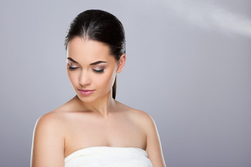 Young woman with ponytail looking down