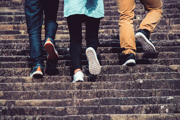 going up the stairs , three friend walking up stair