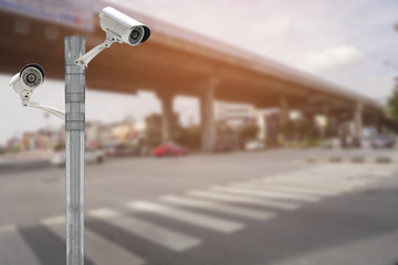 CCTV security camera on traffic road and urban scene.