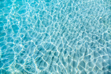 blue clear transparent water background with sand