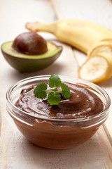 Sticker - raw vegan pudding with avocado and banana on a light wooden background