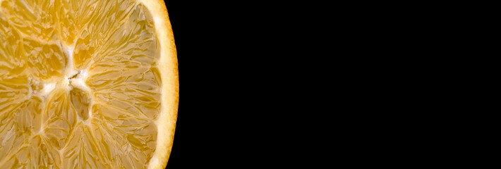 sliced orange closeup isolated on black background