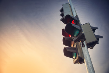 Trafficlights outdoors in early morning with red light